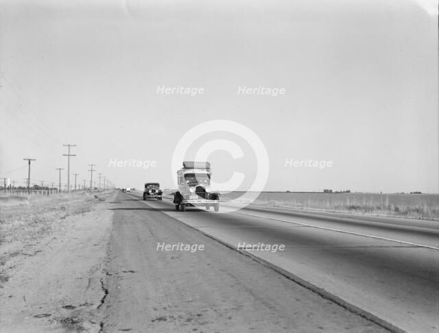 Migrants on the road, between Tulare and Fresno, California, 1939. Creator: Dorothea Lange.