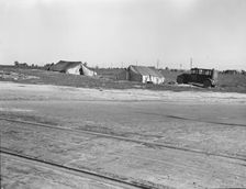 Migrants tents...along the right of way of the southern pacific, near Fresno, California, 1939. Creator: Dorothea Lange