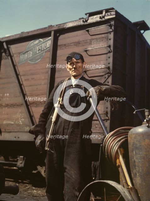 Mike Evans, a welder, at the rip tracks at Proviso yard of the C & NW RR, Chicago, Ill., 1943. Creator: Jack Delano.