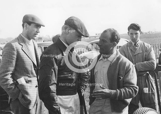 Mike Hawthorn and Stirling Moss chatting at Goodwood 1956. Creator: Unknown.