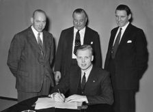 Mike Hawthorn signing Vanwall contract 1955. Creator: Unknown