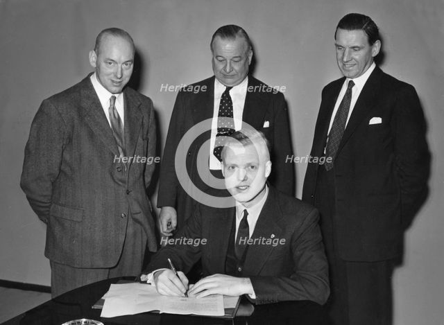 Mike Hawthorn signing Vanwall contract 1955. Creator: Unknown.