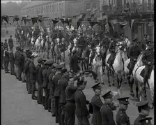 Military Parade of Mounted British Soldiers Riding Down a Street Decorated With Bunting, 1937. Creator: British Pathe Ltd