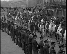 Military Parade of Mounted British Soldiers Riding Down a Street Decorated With Bunting, 1937. Creator: British Pathe Ltd