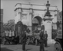 Milk Churns on a Lorry Being Driven Into a London Park as Police Officers Guard It, 1926. Creator: British Pathe Ltd