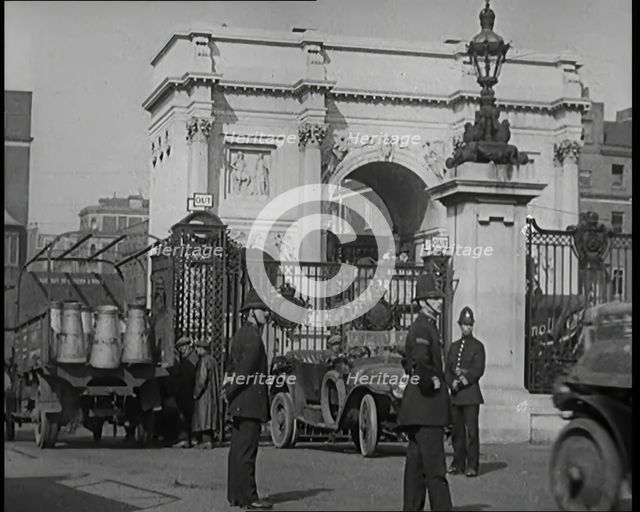 Milk Churns on a Lorry Being Driven Into a London Park as Police Officers Guard It, 1926. Creator: British Pathe Ltd.