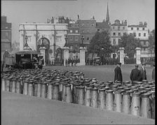 Milk Churns Lining the Street, 1926. Creator: British Pathe Ltd