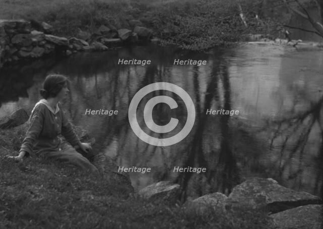 Millay, Edna St. Vincent, Miss, seated next to a pond, 1914. Creator: Arnold Genthe.