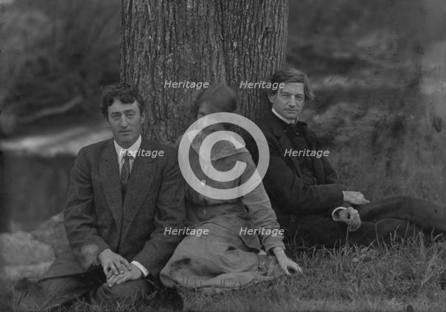 Millay, Edna St. Vincent, Miss, with Bliss Carman and George Sterling, seated against a tree, 1914. Creator: Arnold Genthe.