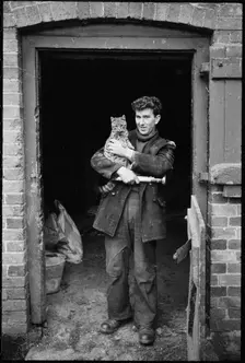 Miller holding a cat, Henley Mill, Henley, Bitterley, Shropshire, 1960-1968. Creator: Rex Wailes
