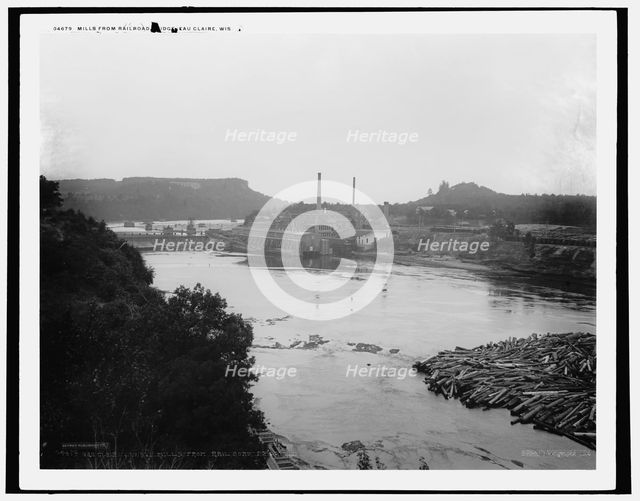 Mills from railroad bridge, Eau Claire, Wis., between 1880 and 1899. Creator: Unknown.