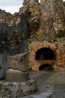 Millstone and oven in the pistrinum, (bakery), Pompeii, Italy, 2009. Creator: LTL