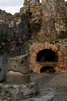 Millstone and oven in the pistrinum, (bakery), Pompeii, Italy, 2009. Creator: LTL