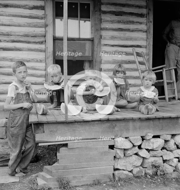 Millworker's children eating watermelon on porch of rented house, Person County, N Carolina, 1939. Creator: Dorothea Lange.