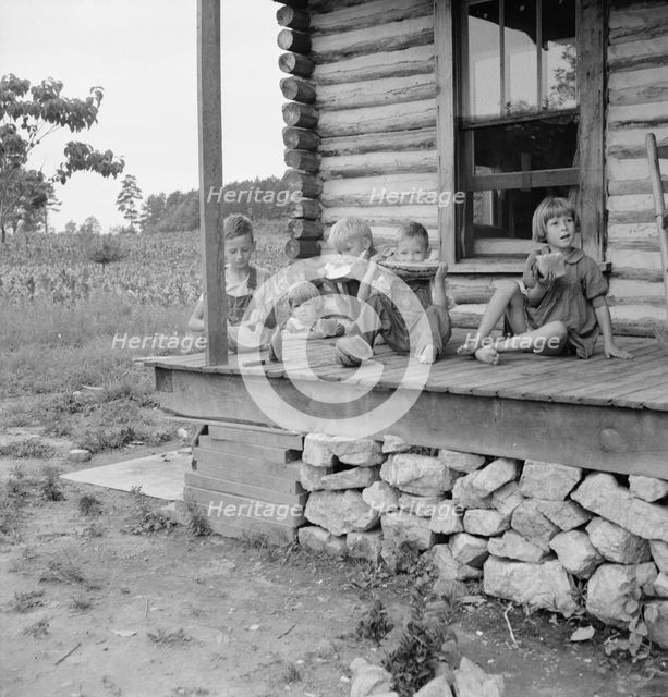 Millworker's children eating watermelon on porch..., Person County, North Carolina, 1939. Creator: Dorothea Lange.