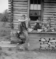 Millworker's children eating watermelon on porch..., Person County, North Carolina, 1939. Creator: Dorothea Lange