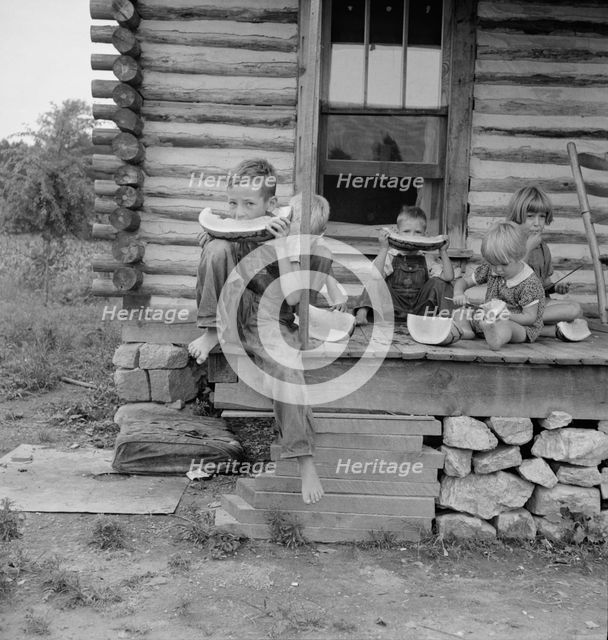 Millworker's children eating watermelon on porch..., Person County, North Carolina, 1939. Creator: Dorothea Lange.