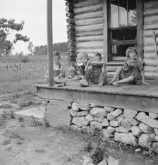Millworker's children eating watermelon on porch..., Person County, North Carolina, 1939. Creator: Dorothea Lange