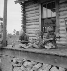 Millworker's children eating watermelon on porch..., Person County, North Carolina, 1939. Creator: Dorothea Lange