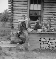 Millworker's children eating watermelon on porch..., Person County, North Carolina, 1939. Creator: Dorothea Lange