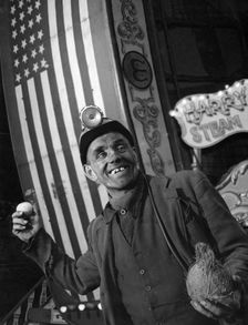 Miner at a fairground, Conisbrough, near Doncaster, South Yorkshire, 1955. Artist: Michael Walters