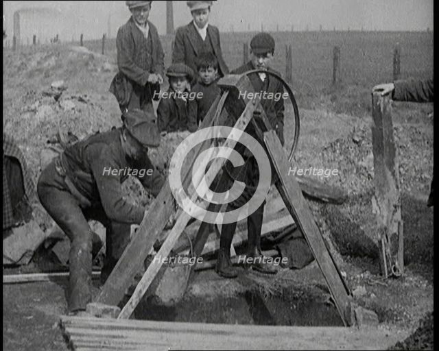 Miners Retrieving Coal from a Shallow Surface Mine, 1921. Creator: British Pathe Ltd.
