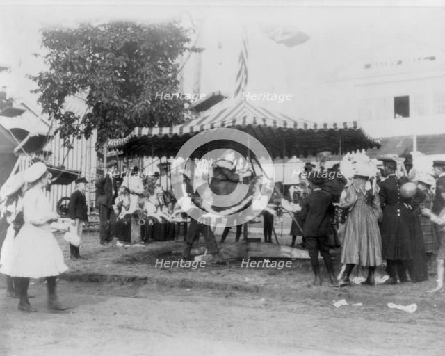 Minnesota State Fair: children on small merry-go-round, 1900?. Creator: Unknown.