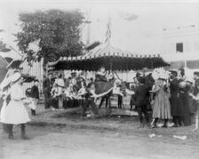 Minnesota State Fair: children on small merry-go-round, 1900?. Creator: Unknown