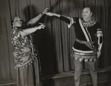 Minto Cato as Azucena and Parker Watkins as Manrico, swearing vengeance on a sword, 1936. Creator: Eagle Ezzes & Mipaas
