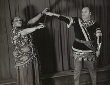 Minto Cato as Azucena and Parker Watkins as Manrico, swearing vengeance on a sword, 1936. Creator: Eagle Ezzes & Mipaas