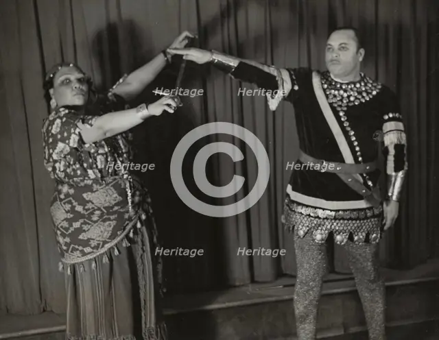 Minto Cato as Azucena and Parker Watkins as Manrico, swearing vengeance on a sword, 1936. Creator: Eagle Ezzes & Mipaas.