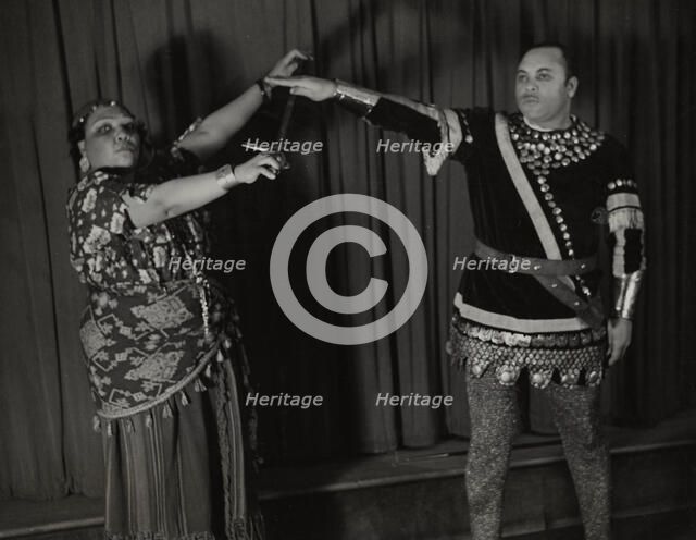 Minto Cato as Azucena and Parker Watkins as Manrico, swearing vengeance on a sword, 1936. Creator: Eagle Ezzes & Mipaas.