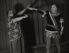 Minto Cato as Azucena and Parker Watkins as Manrico, swearing vengeance on a sword, 1936. Creator: Eagle Ezzes & Mipaas