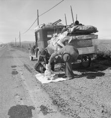 Missouri family of five on U.S. Highway 99 near Tracy, California, 1937. Creator: Dorothea Lange