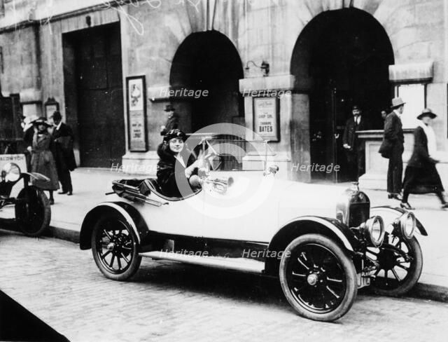 Miss Evelyn Laye sitting in a parked car, (1920s?). Artist: Unknown