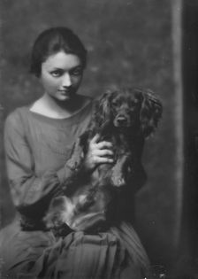 Miss Katharine Cornell, with dog, portrait photograph, 1917 Nov. 20. Creator: Arnold Genthe