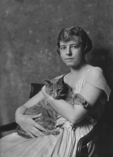 Miss Marjorie Cluett, with Buzzer the cat, portrait photograph, 1917 Dec. Creator: Arnold Genthe
