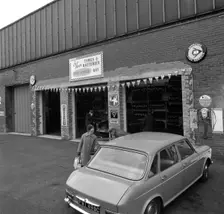 Mk 1 BMC Austin 1800 outside a tyre fitting bay in Rotherham, South Yorkshire, 1969. Creator: Michael Walters