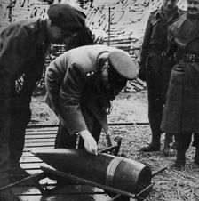 Mr. Churchill autographing a present for Hitler c1940s, (1945)
