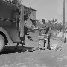 Mr. and Mrs. Venue Alsobrook wrapping papers for the government salvage..., Washington, D.C., 1942. Creator: Gordon Parks