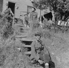 Mr. and Mrs. Venus Alsobrook in front of their home in the southwest section, Washington, DC, 1942. Creator: Gordon Parks