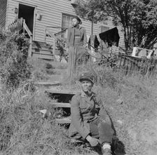 Mr. and Mrs. Venus Alsobrook in front of their home in the southwest section, Washington, DC, 1942. Creator: Gordon Parks