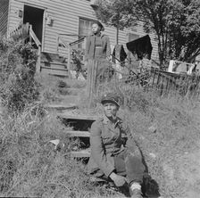 Mr. and Mrs. Venus Alsobrook in front of their home in the southwest section, Washington, DC, 1942. Creator: Gordon Parks