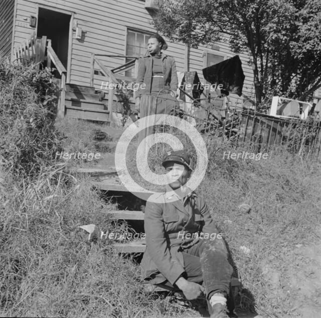 Mr. and Mrs. Venus Alsobrook in front of their home in the southwest section, Washington, DC, 1942. Creator: Gordon Parks.