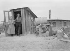 Mr. and Mrs. Wardlow at entrance to their dugout...home, Dead Ox Flat, Malheur County, Oregon, 1939. Creator: Dorothea Lange