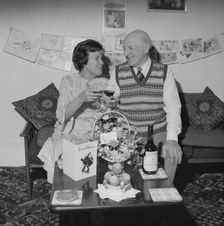 Mr and Mrs Birtmead toasting to their golden wedding anniversary, 26/04/1984. Creator: John Laing plc