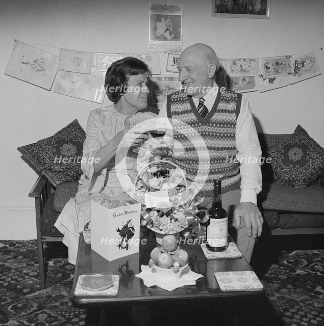 Mr and Mrs Birtmead toasting to their golden wedding anniversary, 26/04/1984. Creator: John Laing plc.