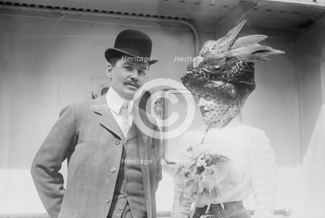 Mr. and Mrs. C.F. Bishop next to train, 1910. Creator: Bain News Service.