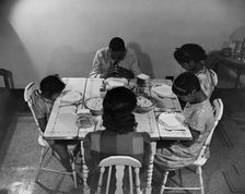 Mr. Branch, resident of the James Creek dwellings, saying grace, Washington, D.C., 1942. Creator: Gordon Parks