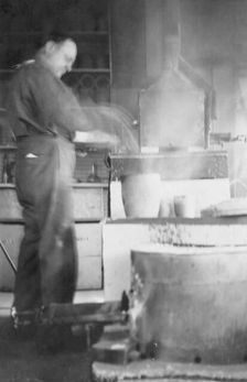 Mr. Kah smelting gold at the Assay Office, between c1900 and 1916. Creator: Unknown